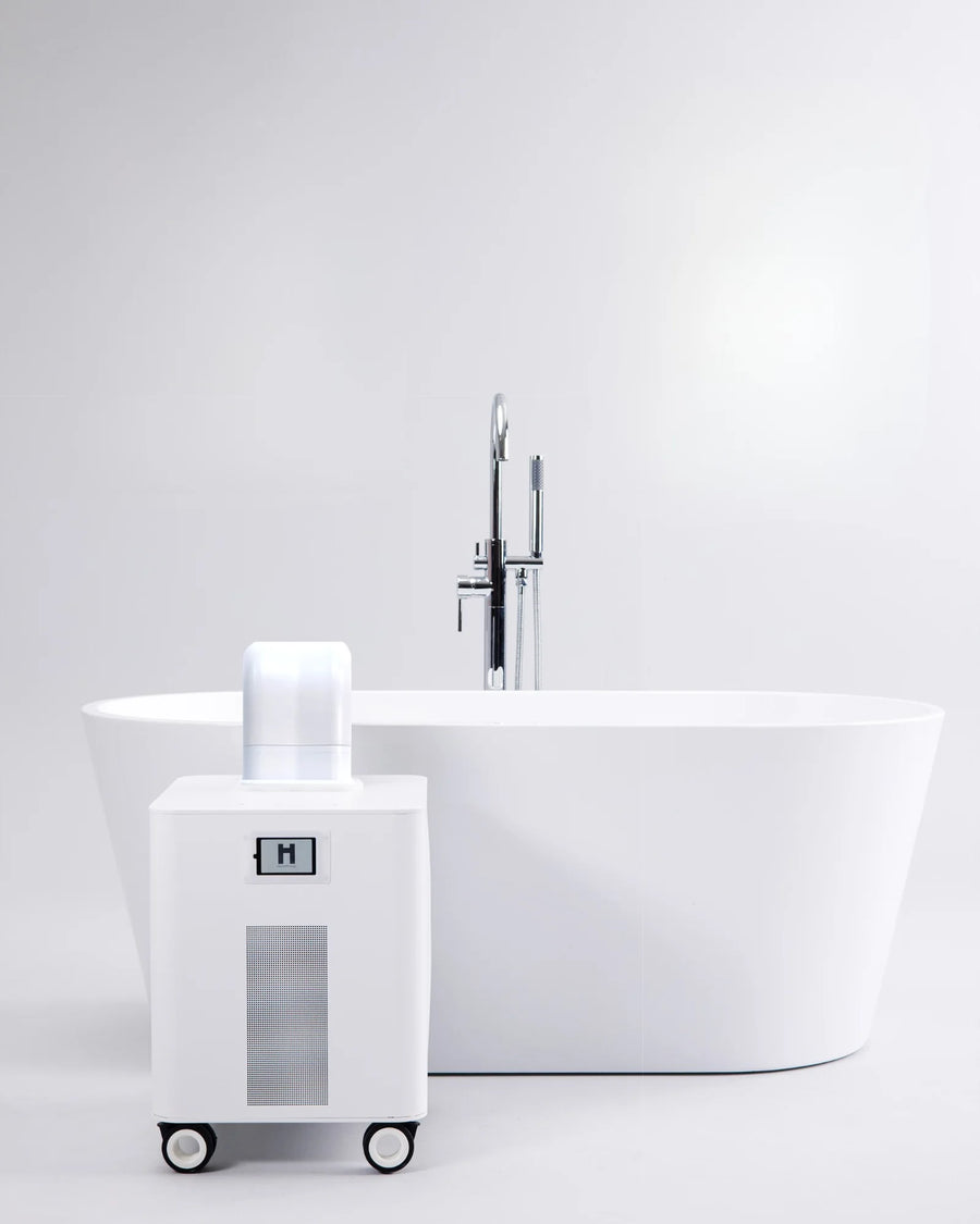 HomePlunge H3 cold plunge chiller beside a freestanding bathtub