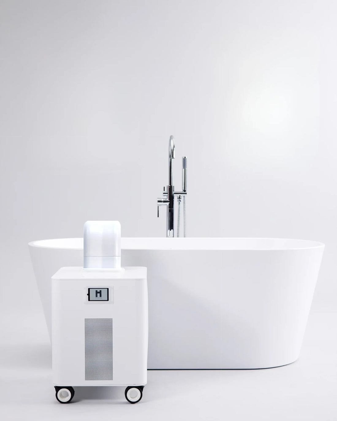 HomePlunge H3 cold plunge chiller beside a freestanding bathtub