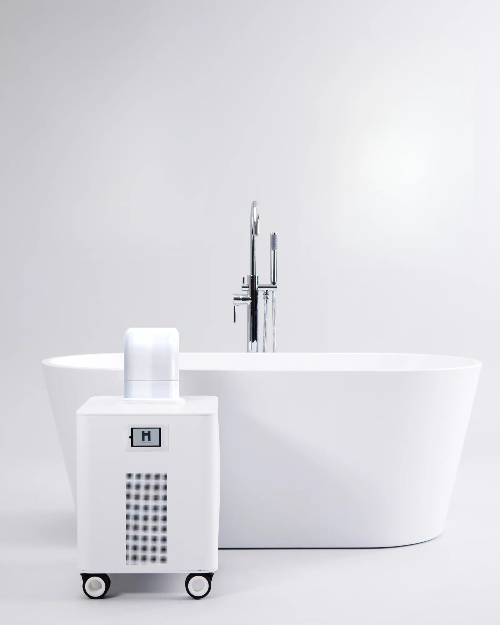 HomePlunge H3 cold plunge chiller beside a freestanding bathtub